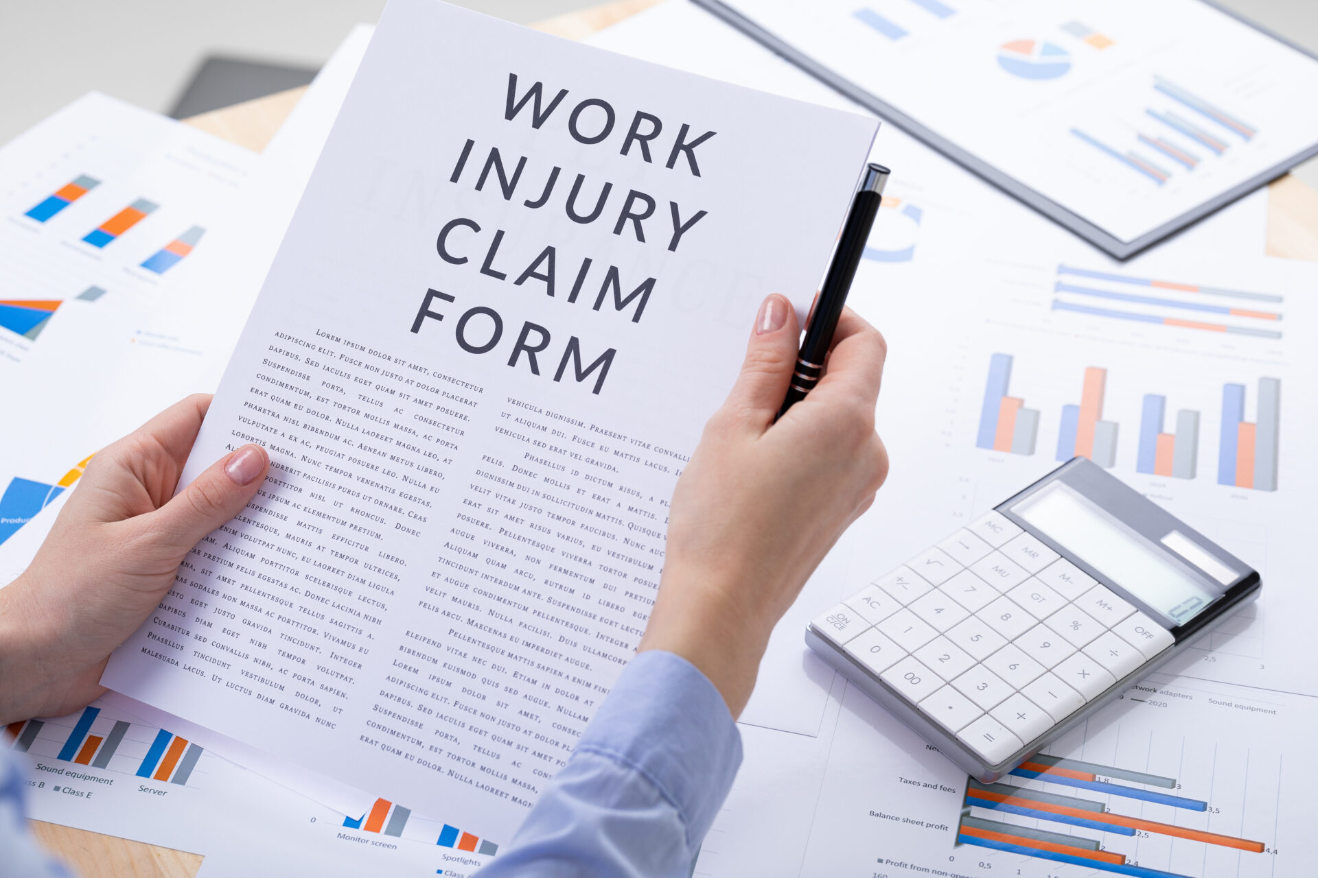 A woman holding a paper with the word work injury claim form for insurance purposes.