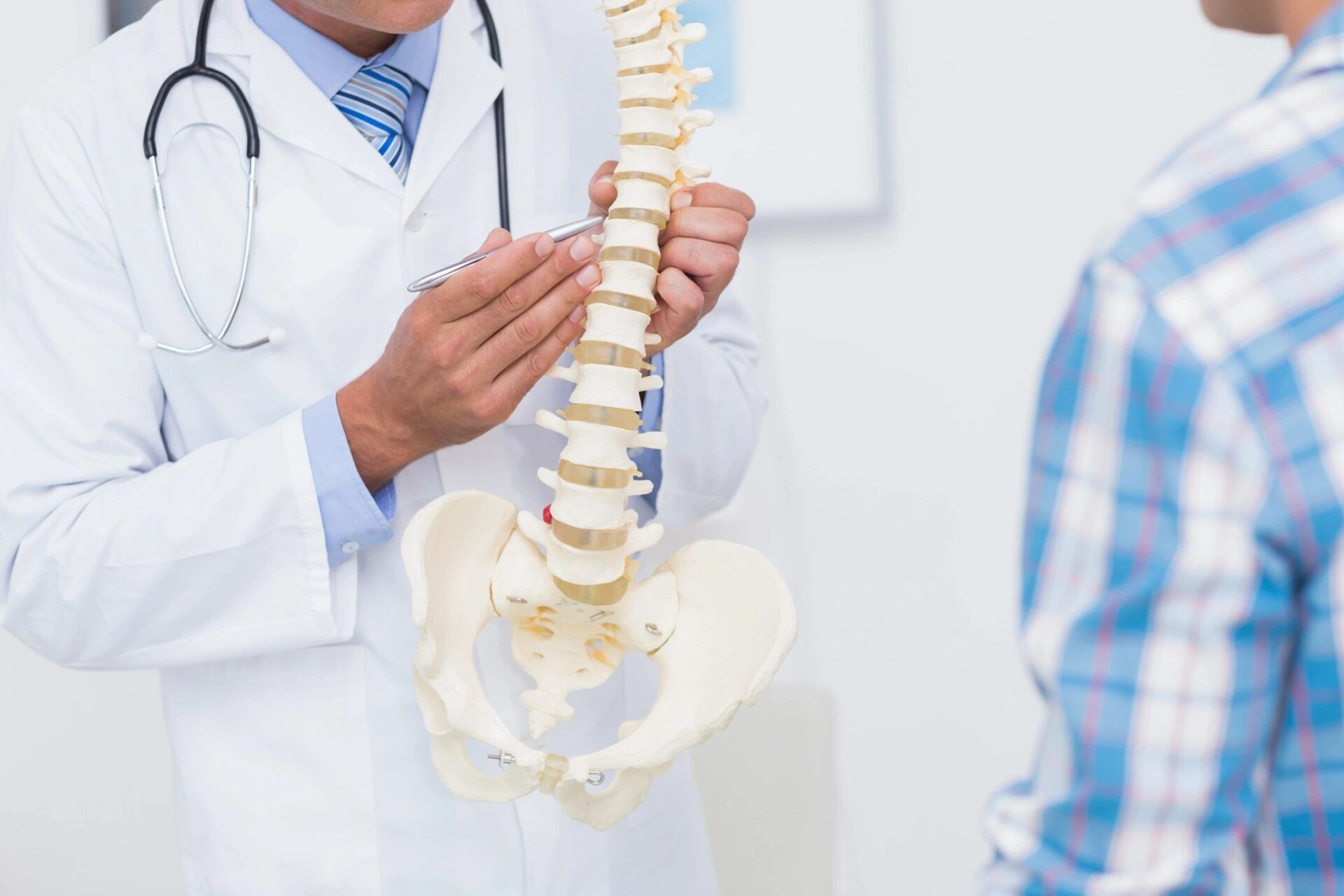 A doctor is looking at a patient's spine.