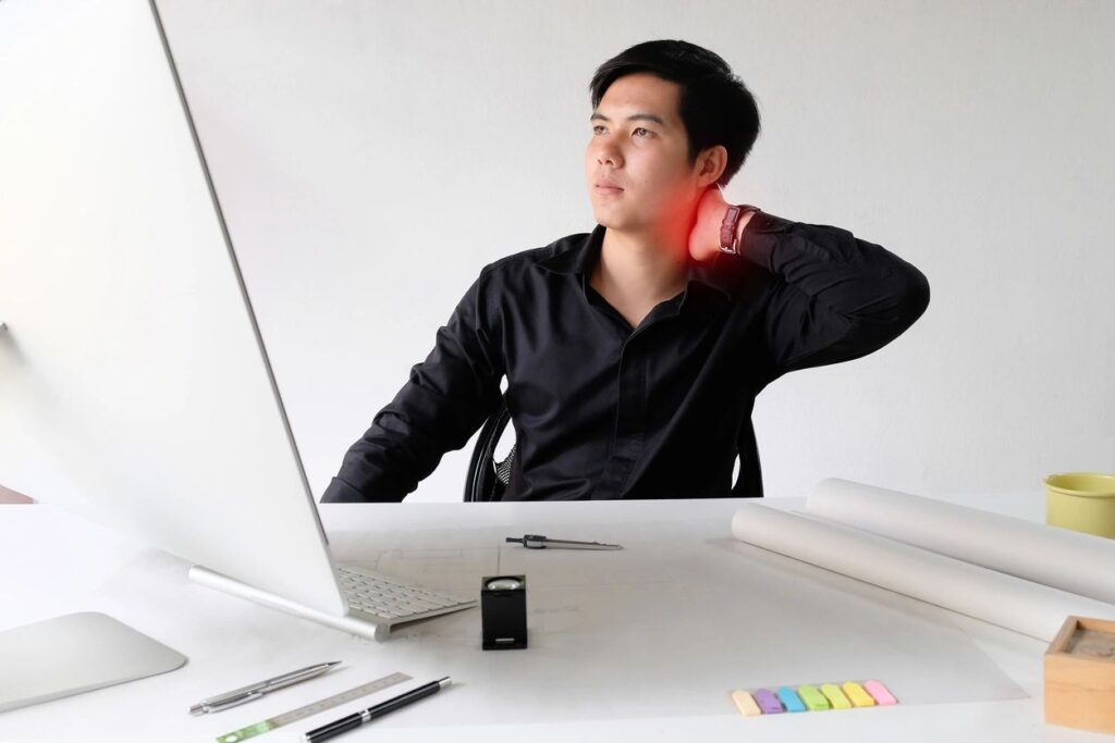 Man holding his neck with pain around the neck area