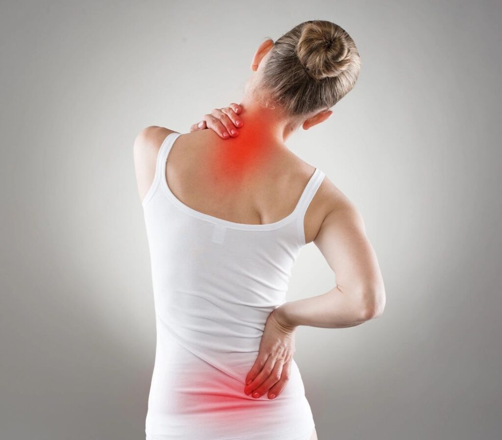 Woman having pain in neck and back area