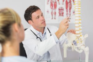 Doctor explaining chiropractic pain to student