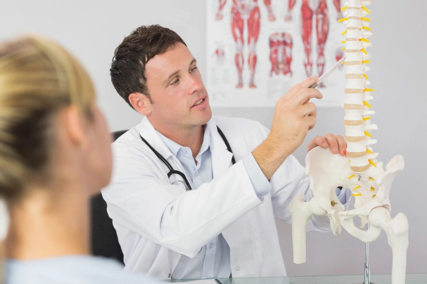 Doctor explaining chiropractic pain to student